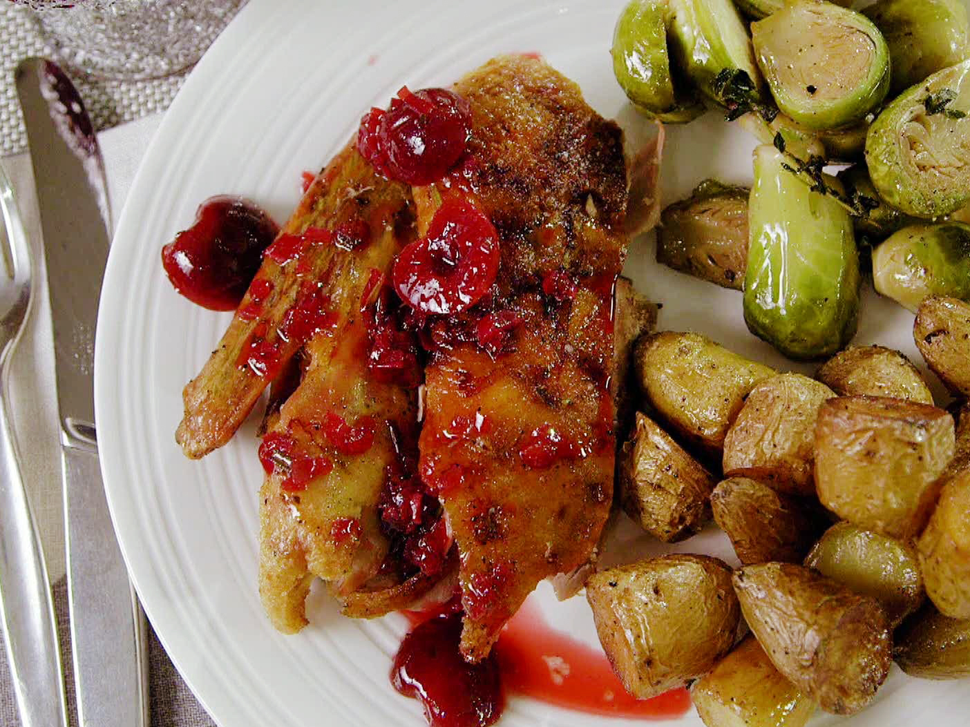 https://www.foodnetwork.com/content/dam/images/food/fullset/2013/5/15/0/ED0308H_crisp-tender-roast-duck-with-cherry-rosemary-sauce-recipe_s4x3.jpg