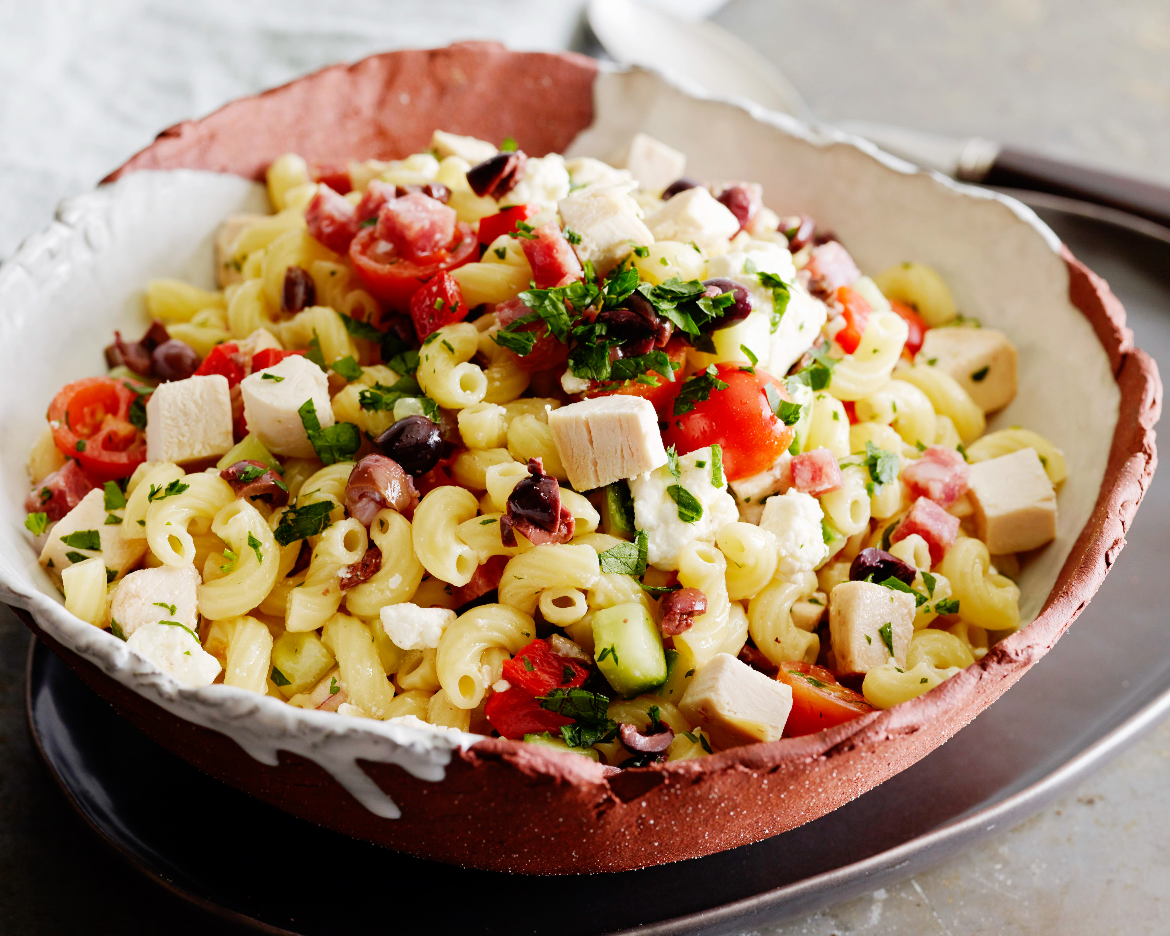 Classic italian orzo pasta salad, complete with a homemade dressing and min...